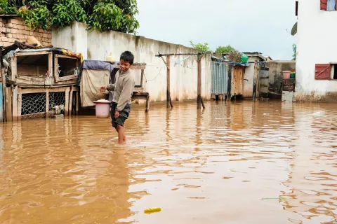 A boy in water up to his ankles after a tropical storm in Madagascar