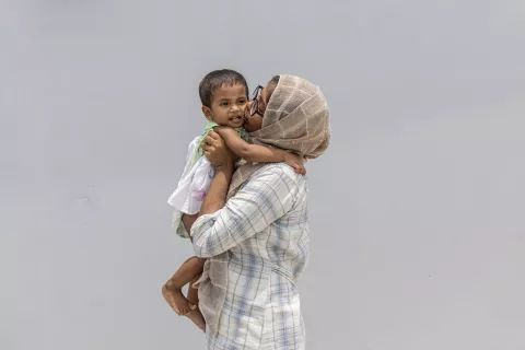 A mother kisses her daughter in Bangladesh