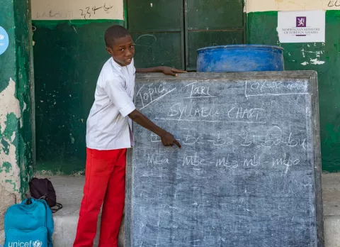 Students points at a chalkboard at a primary school in northeast Nigeria.