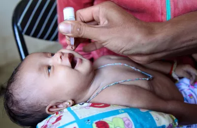A child is administered an oral vaccine during a routine immunization session at the health centre in the village of Preak Krabao, Kang Meas District, Cambodia