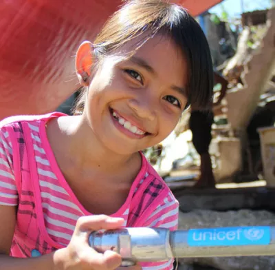 girl washing her hands with unicef supported tap