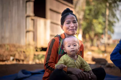 A mother, 30 years-old, holds her child of 16 months who received vaccination during integrated health outreach activities in Ten Ngol village, Cambodia