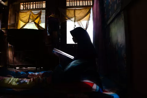 Mara (not her real name), 15, reads in her bedroom at home in Bone, South Sulawesi Province, Indonesia