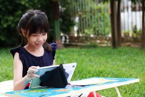 Girl playing on her tablet