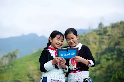 Tan Thanh Hien (left) 11 years old and her friend Tan Thi Hang (right) 11 years old, were trying the AR technology on the tablet supported by UNICEF at Bat Xat secondary high school in Lao Cai.