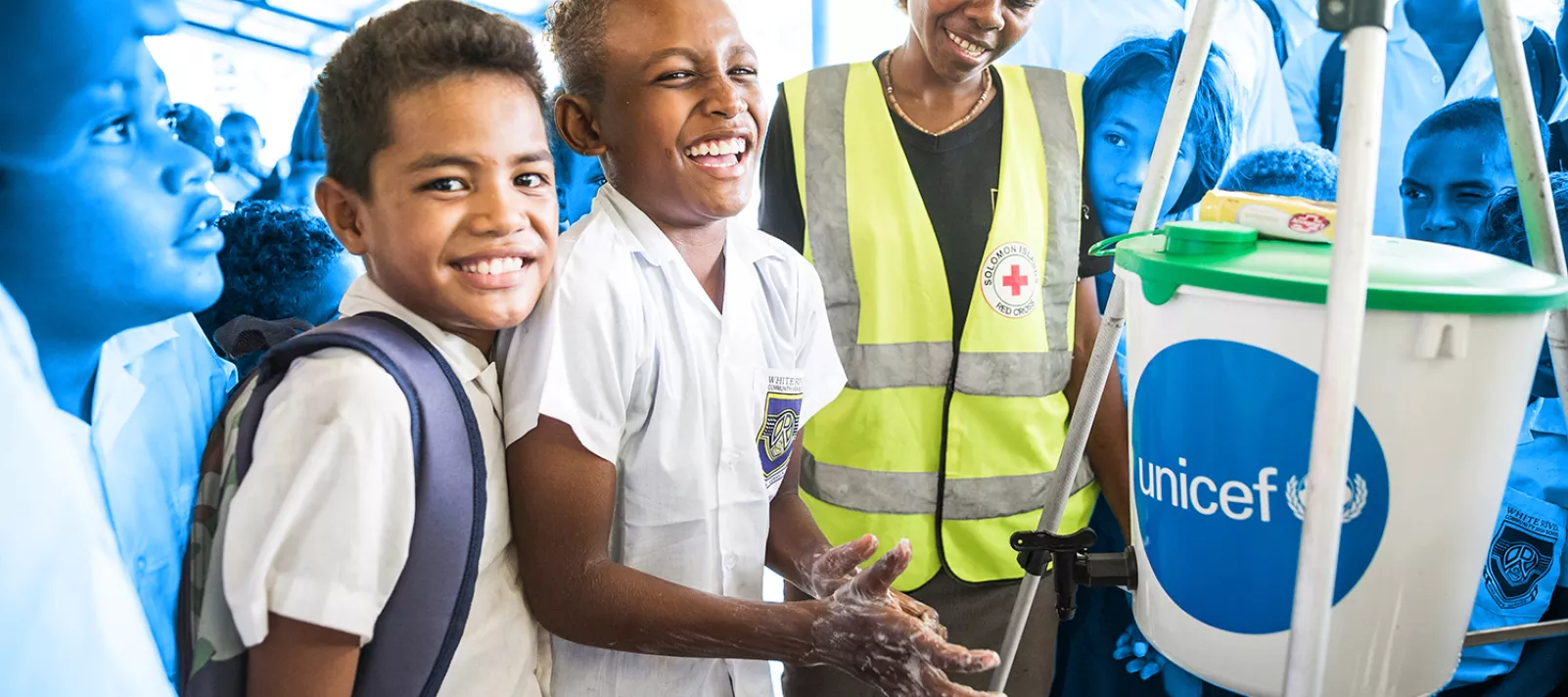 Grade 3 student of White River School in Honiara, Patty Patrick, 10, washing his hands next to a Red Cross staff member during a workshop organised by UNICEF with their partners from the Red Cross. During the workshop Red Cross workers showed children how to properly use hygiene items