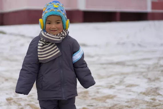 a child in UNICEF-supported warm weather clothes in Northern DPR Korea