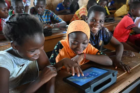 Students looking at a tablet screen during school.