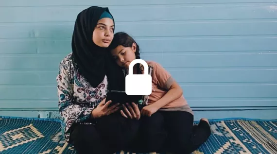 In Jordan, Hala, 15, teaches her younger sister how to use a tablet in their home at the Za'atari Refugee Camp.