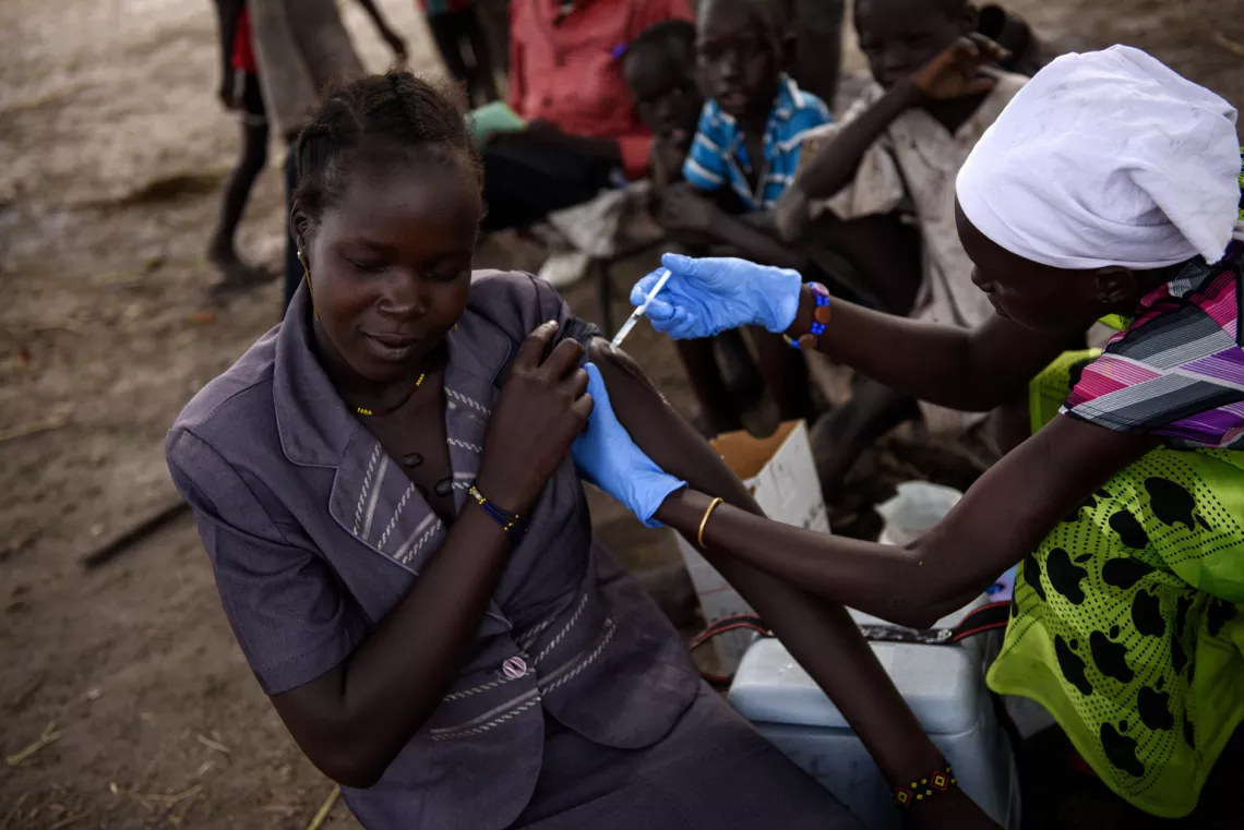 A health volunteer administers a tetanus vaccine to a woman in Koch county, South Sudan.
