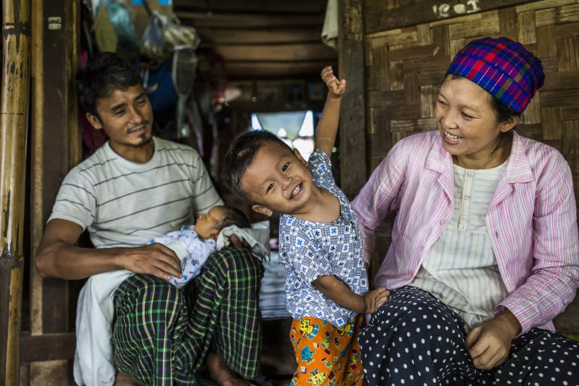 Ze Naw, 36, with her husband Kumje Tu Mai, 43, and their children sitting outside their family’s shelter-room, at Maina camp for internally displaced persons in Waingmaw, Kachin State, Myanmar.