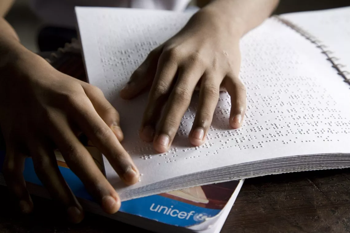 Mahesh Yadav, 13, reading in Braille. He is blind from birth and has been living in an academy for the blind for over six years in India.